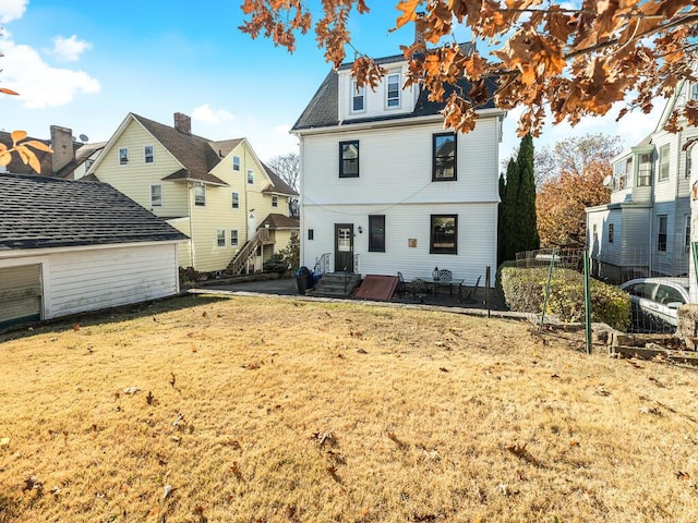 rear view of property with a yard