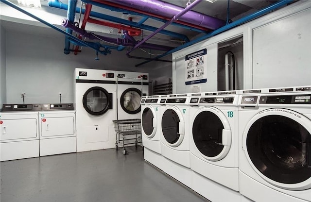 clothes washing area featuring washer and clothes dryer