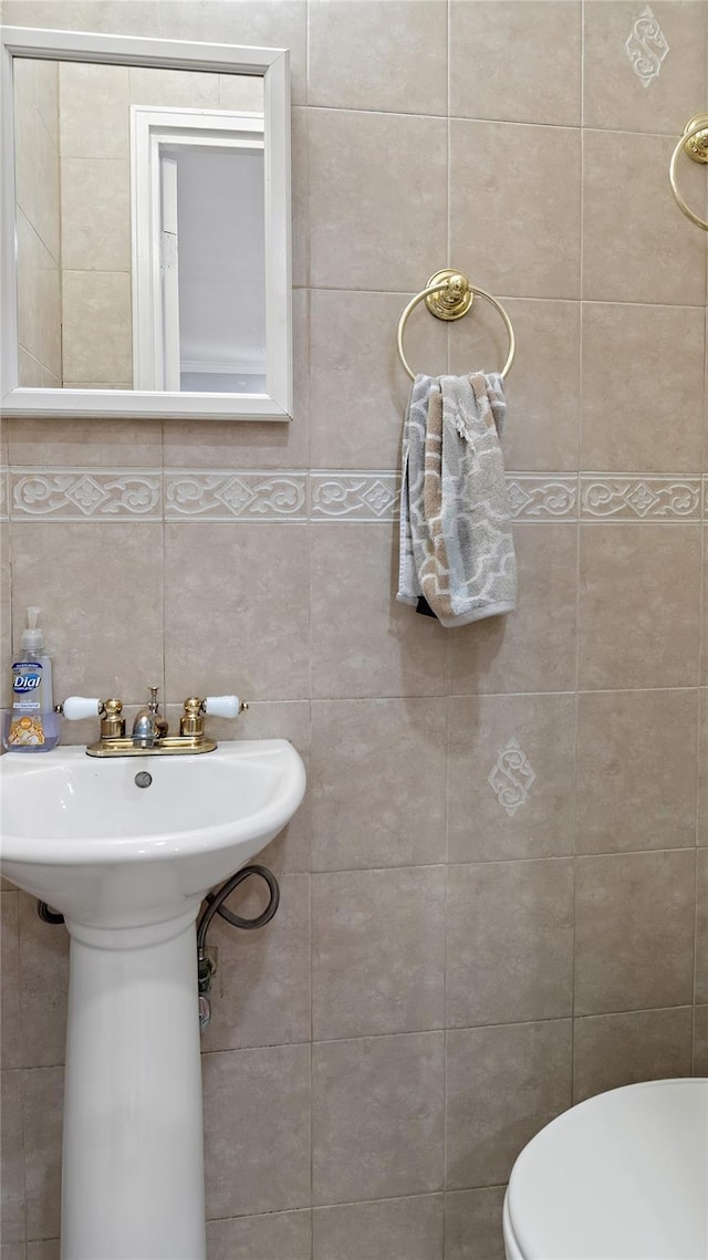 3207 Ampere Ave, Bronx, NY 10465 - half bathroom with toilet, tile walls, a sink, and tasteful backsplash