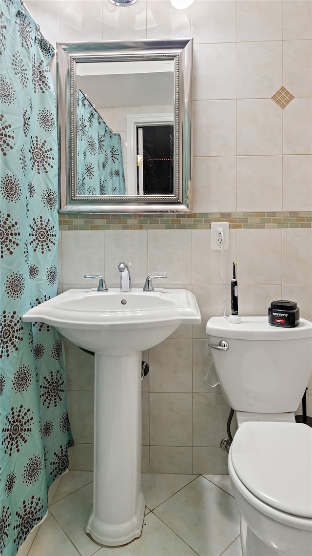 bathroom with tile patterned flooring, backsplash, toilet, and tile walls