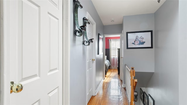 hallway with light hardwood / wood-style floors