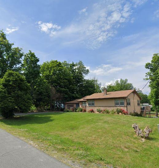 ranch-style home with a front lawn