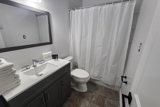 full bathroom featuring vanity, shower / bath combo, and toilet