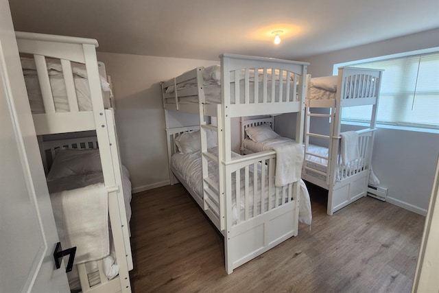 bedroom featuring hardwood / wood-style floors and a baseboard radiator