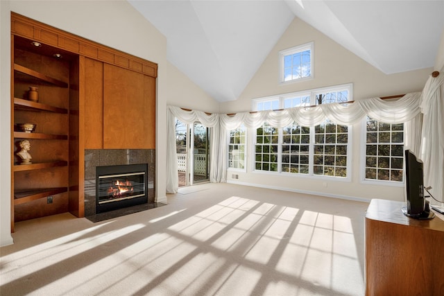 unfurnished living room featuring lofted ceiling, light colored carpet, and a healthy amount of sunlight