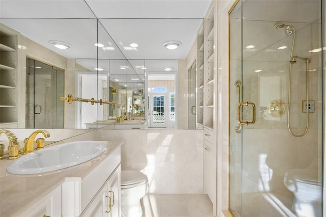 bathroom featuring tile patterned flooring, vanity, toilet, and walk in shower