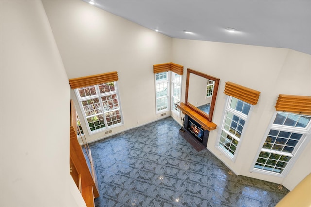 living room featuring dark colored carpet and high vaulted ceiling