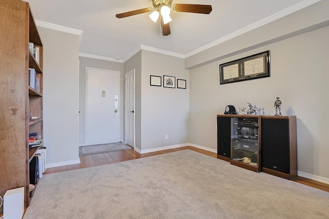 foyer entrance featuring crown molding, ceiling fan, and light wood-type flooring