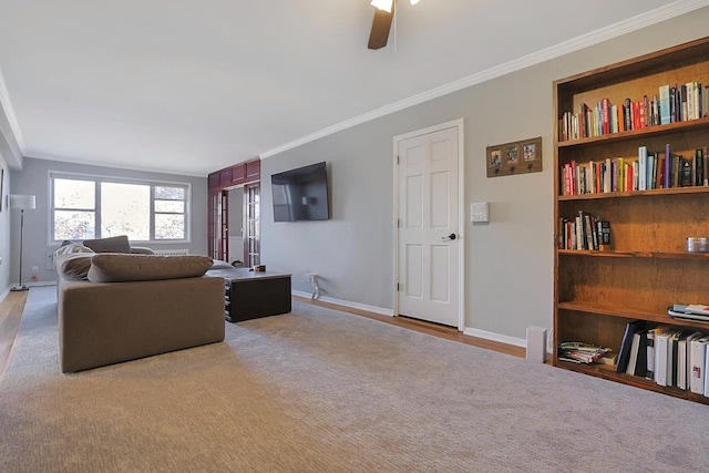living room featuring light carpet, ceiling fan, and crown molding