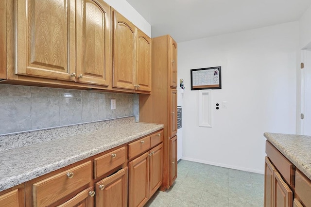 kitchen featuring light tile patterned floors and tasteful backsplash