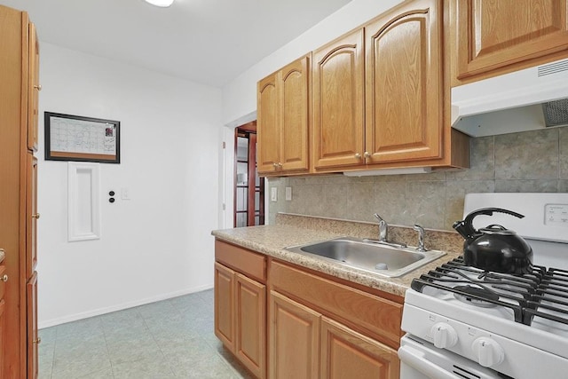 kitchen featuring backsplash, light tile patterned floors, sink, and gas range gas stove
