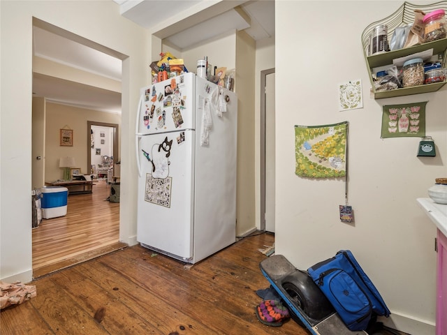 kitchen with white refrigerator and dark wood-type flooring