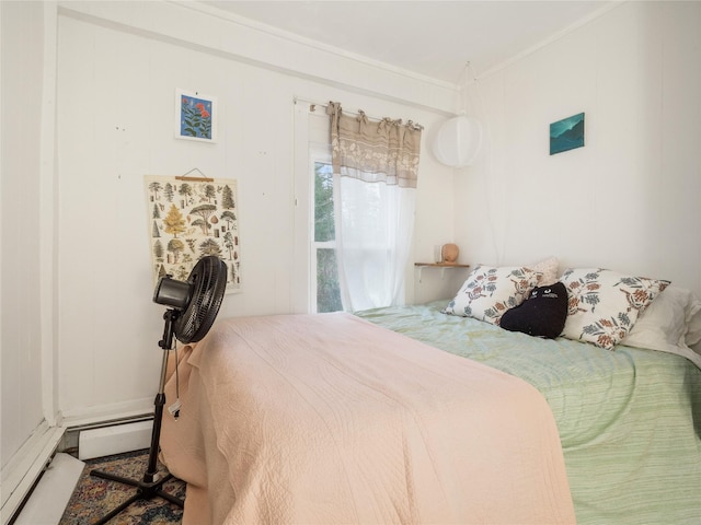 bedroom with crown molding and a baseboard radiator