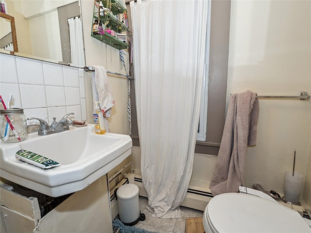 bathroom featuring tasteful backsplash, tile patterned floors, sink, a baseboard radiator, and toilet