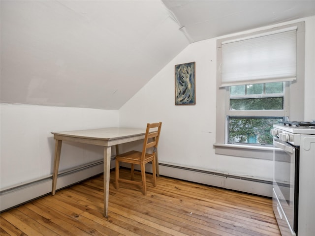 home office with lofted ceiling, light wood-type flooring, and baseboard heating