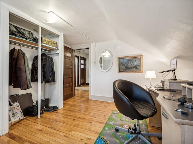 home office featuring light hardwood / wood-style flooring and lofted ceiling