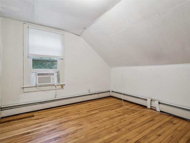 bonus room featuring a baseboard heating unit, cooling unit, vaulted ceiling, and light wood-type flooring