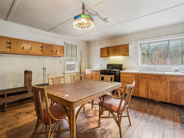 dining area with dark hardwood / wood-style flooring and sink