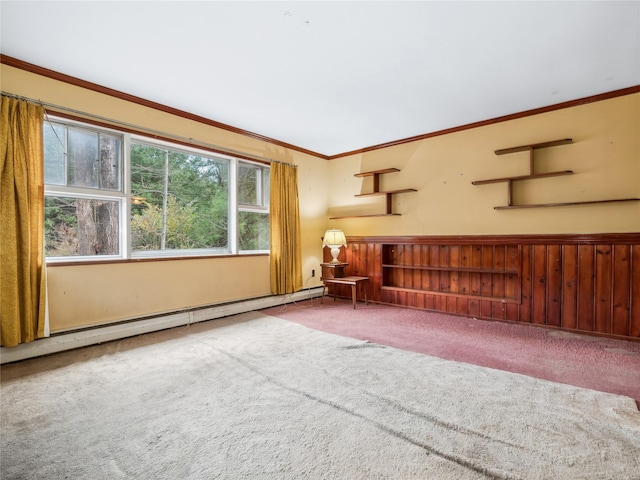 unfurnished living room with baseboard heating, crown molding, carpet floors, and wood walls