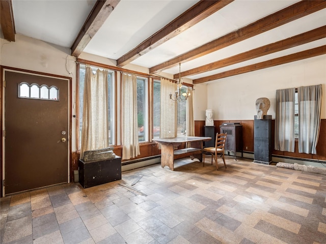 interior space with baseboard heating, beamed ceiling, and a notable chandelier