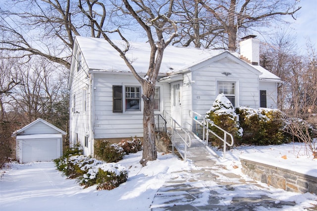 bungalow-style house with an outbuilding and a garage