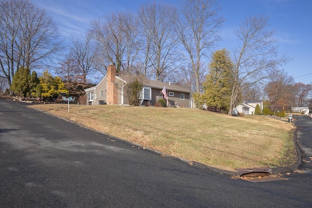 ranch-style home with a front lawn