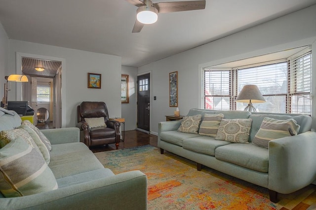 living room with ceiling fan and dark hardwood / wood-style floors