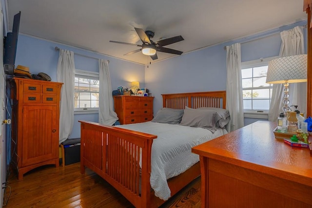 bedroom featuring hardwood / wood-style flooring, ceiling fan, and crown molding