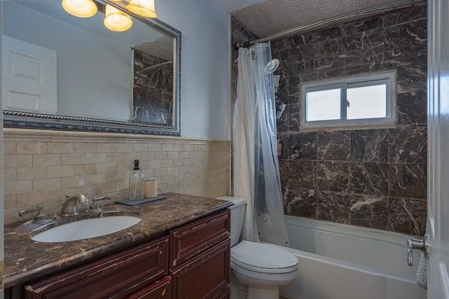 full bathroom featuring tile walls, vanity, toilet, and shower / tub combo