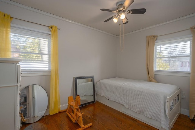 bedroom with ceiling fan, crown molding, and dark hardwood / wood-style flooring