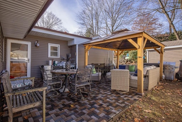 view of patio / terrace with an outdoor living space, a grill, and a gazebo