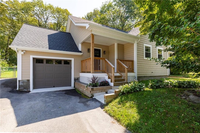 view of front of house featuring covered porch and a garage