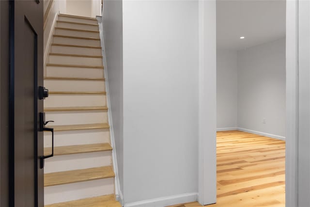 staircase with hardwood / wood-style flooring