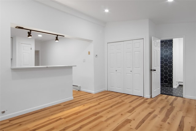 interior space with a baseboard radiator and light wood-type flooring