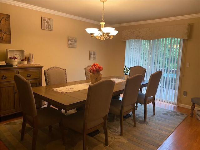 dining area with a chandelier, hardwood / wood-style floors, and ornamental molding