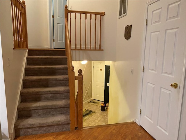 stairs featuring hardwood / wood-style flooring