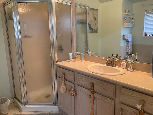 bathroom featuring vanity, tile patterned floors, and a shower with shower door