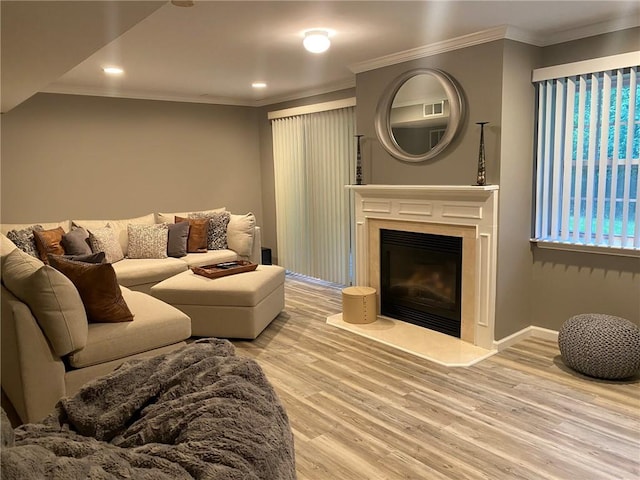 living room featuring crown molding and light hardwood / wood-style flooring