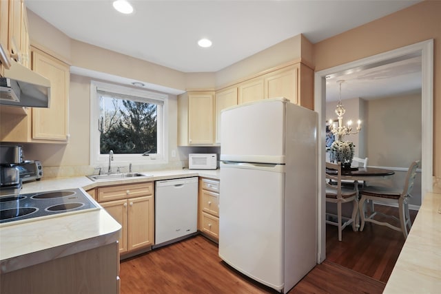 kitchen with light brown cabinets, white appliances, a sink, light countertops, and dark wood finished floors