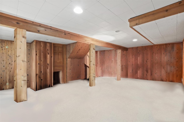 finished basement with wooden walls and carpet flooring