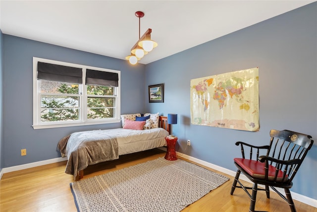 bedroom with wood finished floors and baseboards