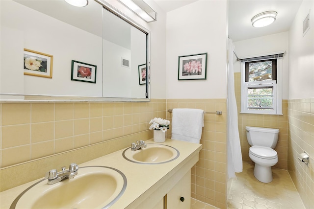 bathroom with a sink, visible vents, toilet, and tile patterned floors