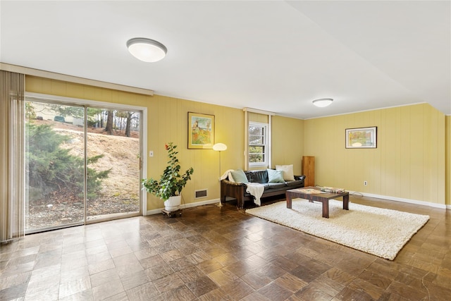 living room featuring baseboards and visible vents