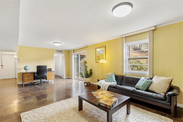 living area featuring baseboards and visible vents