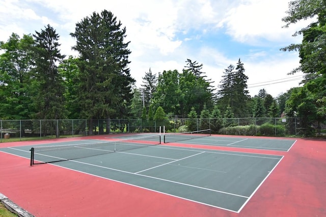 view of sport court featuring fence