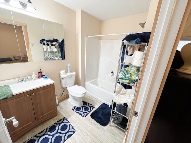 full bathroom with vanity, washtub / shower combination, wood-type flooring, and toilet