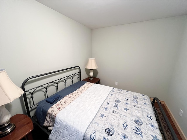 bedroom with hardwood / wood-style floors