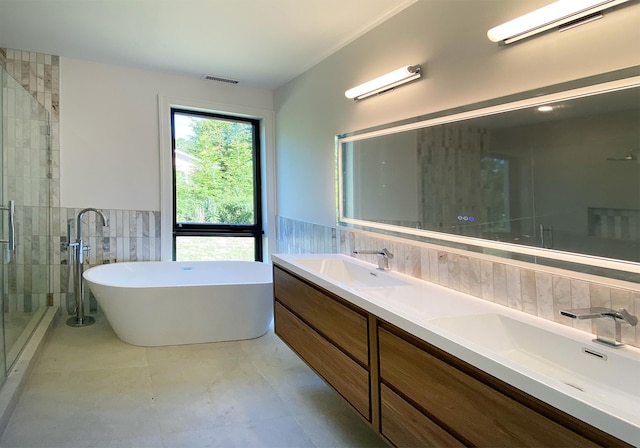 bathroom featuring vanity, independent shower and bath, and tile walls