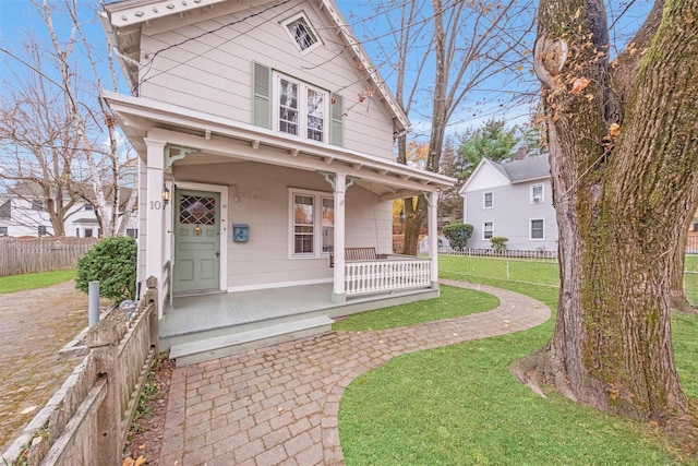 view of front of property with a front yard and covered porch