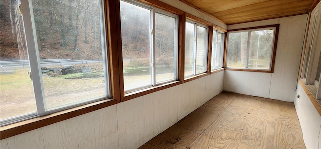 unfurnished sunroom with wood ceiling